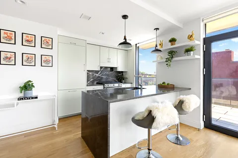 a kitchen with stainless steel appliances granite countertop a sink and a refrigerator