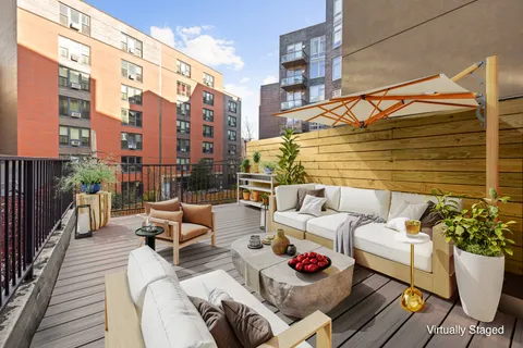 a view of a patio with couches and potted plants