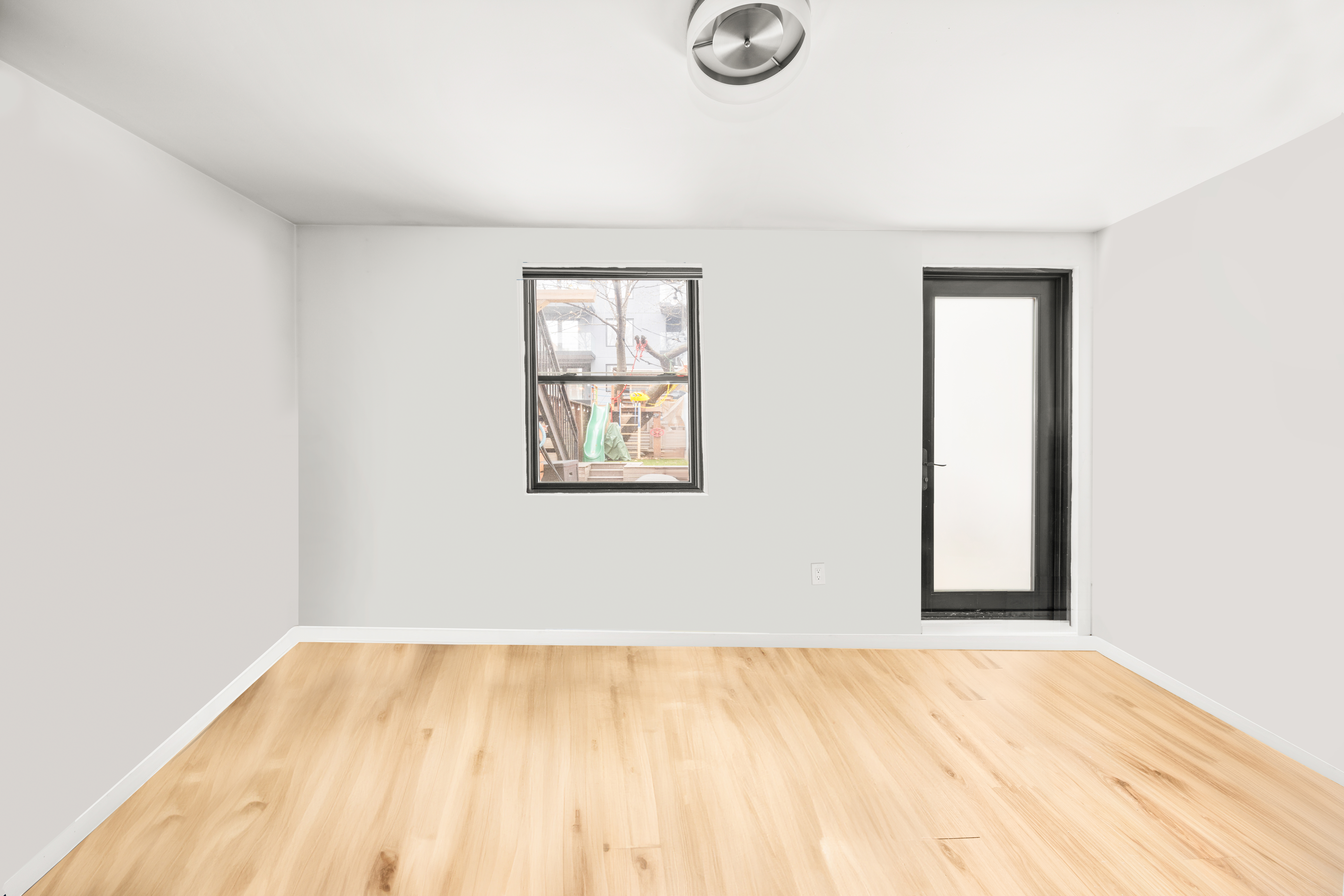 211 14th Street Brooklyn, NY 11215 - Photo 16 of 18 a view of empty room with wooden floor