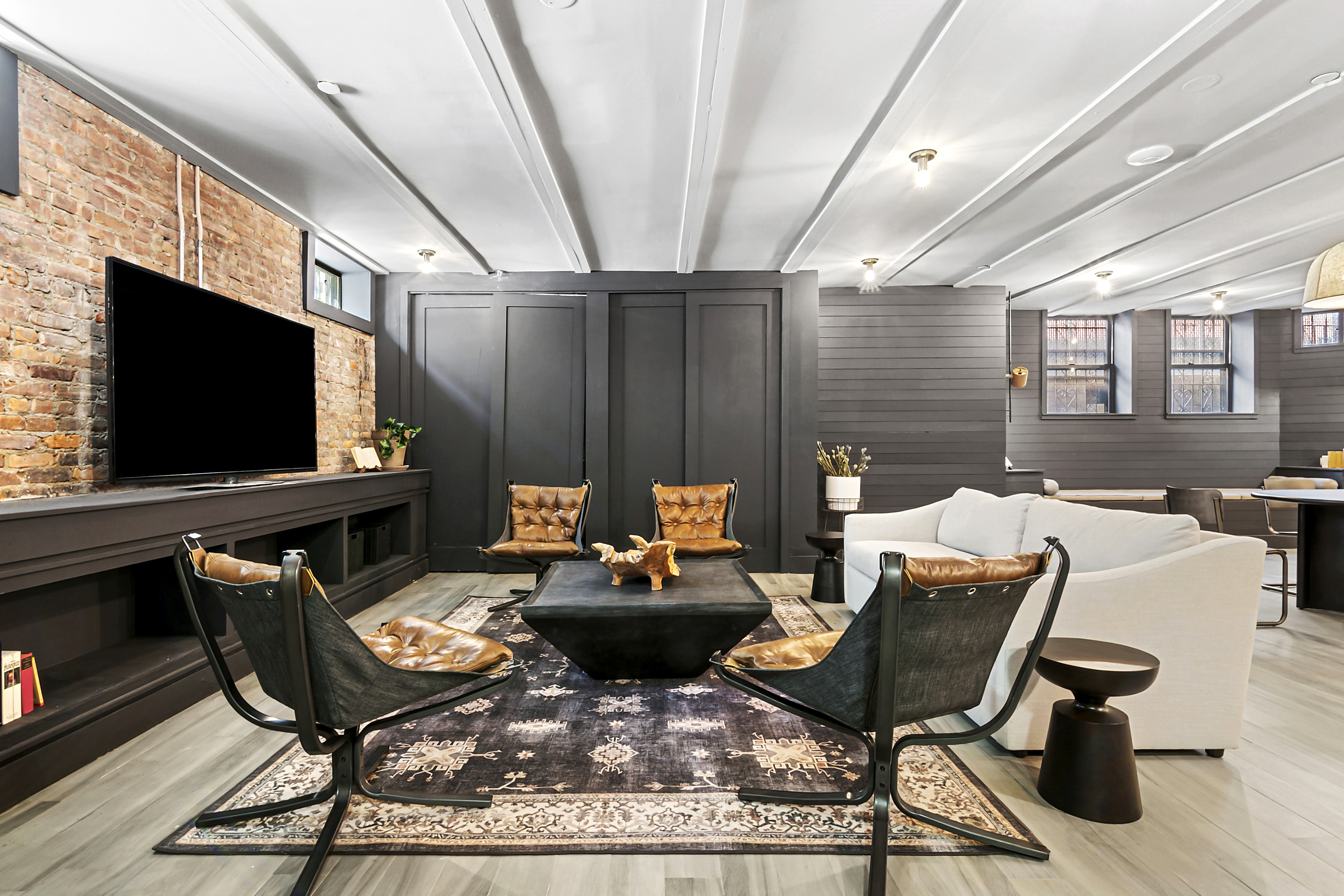 180 Bainbridge Street, Unit 111 Brooklyn, NY 11233 - Photo 13 of 25 a living room with furniture a flat screen tv and a fireplace