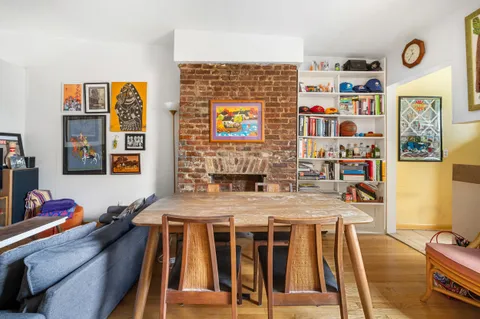a dining room with wooden floor and furniture
