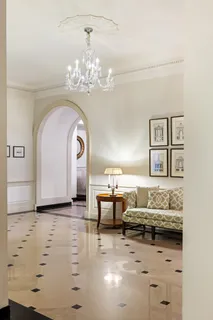 a living room with furniture and chandelier