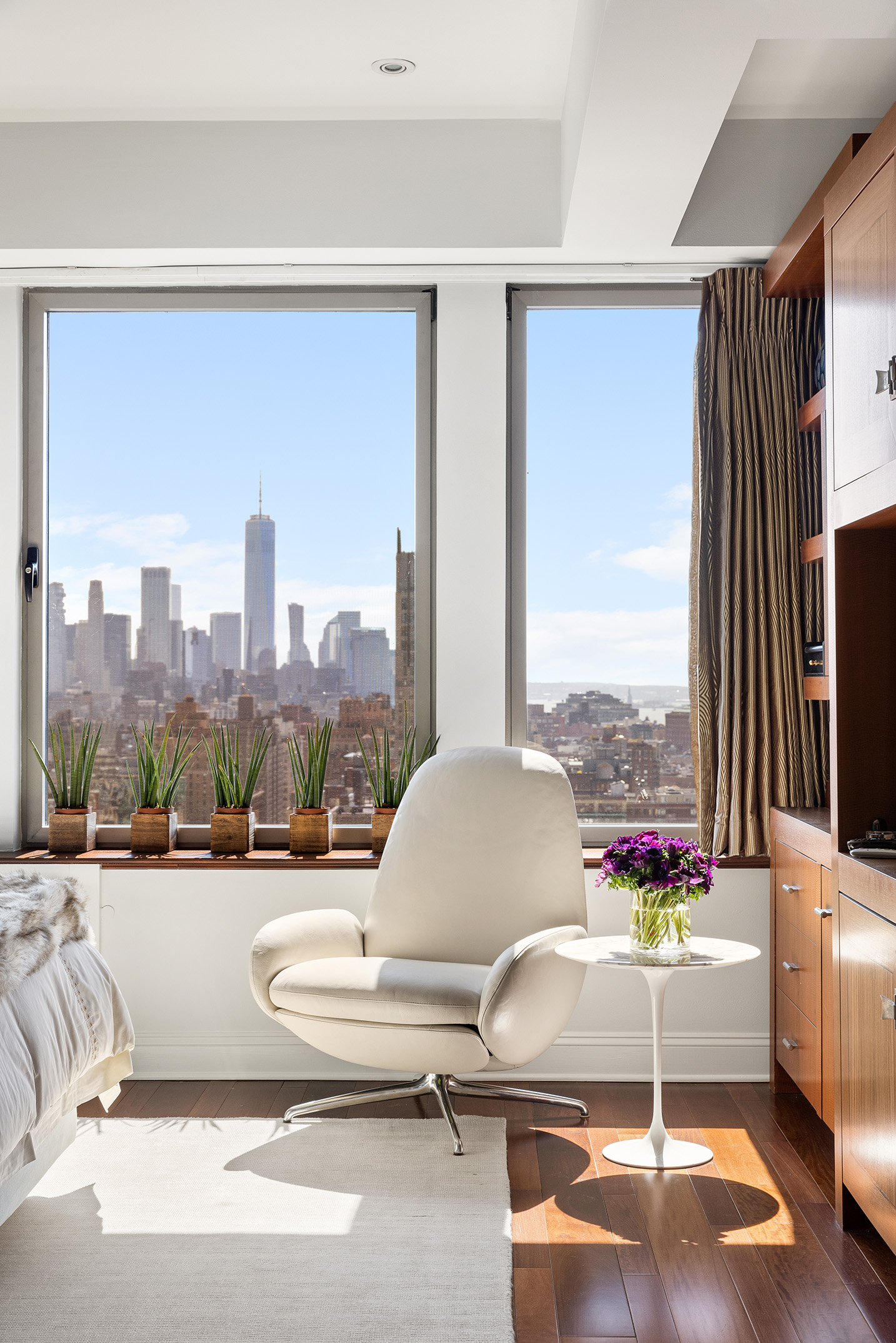 252 7th Avenue, Unit PHG Manhattan, NY 10001 - Photo 19 of 27 a living room with patio furniture and a floor to ceiling window