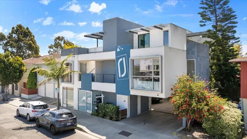 a couple of cars parked in front of a house