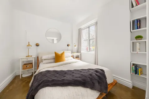 a bedroom with a bed and window