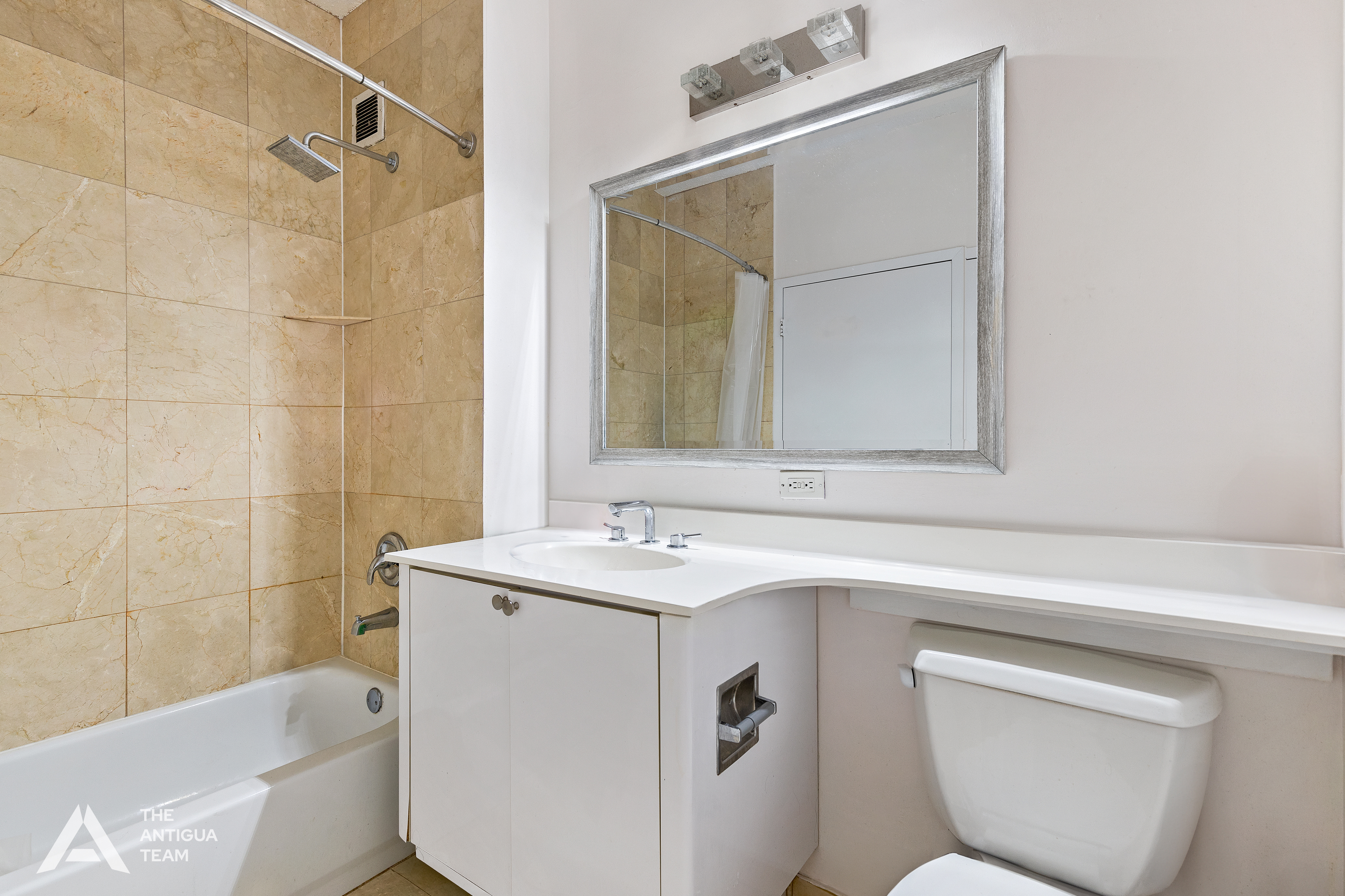 60 Oceana Drive West, Unit 10A Brooklyn, NY 11235 - Photo 8 of 16 a bathroom with a sink toilet vanity and tub