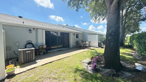 a view of a house with backyard tub and sitting area