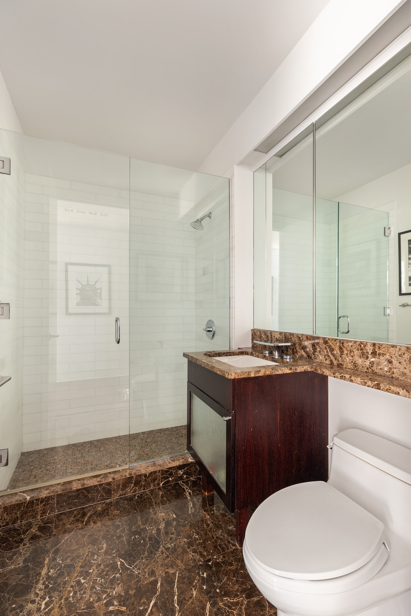 207 East 57th Street, Unit 33B Manhattan, NY 10022 - Photo 7 of 8 a bathroom with a granite countertop toilet sink and mirror