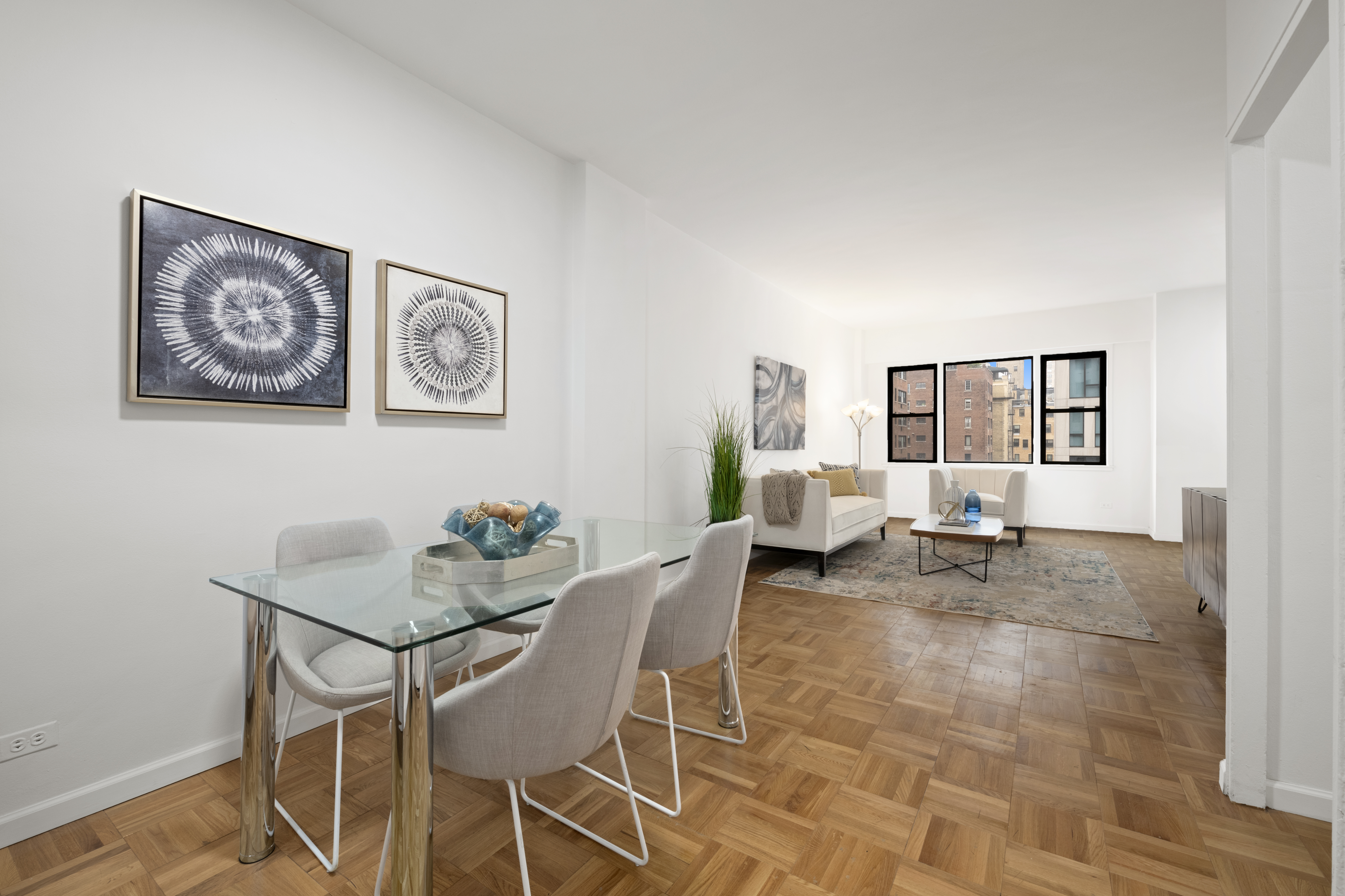 201 East 21st Street, Unit 15C Manhattan, NY 10010 - Photo 3 of 9 a living room with furniture and wooden floor