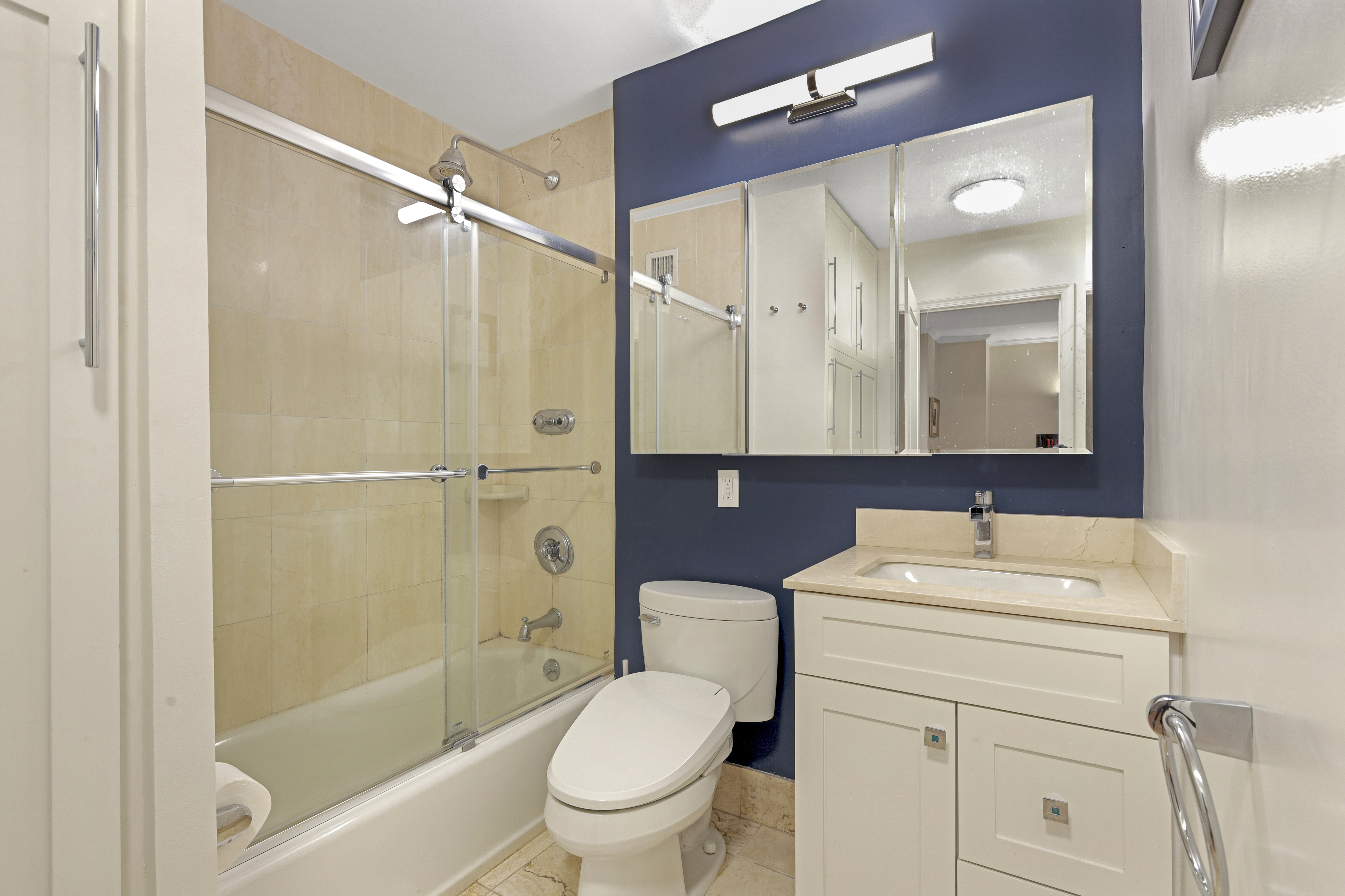 165 West 66th Street, Unit 2S Manhattan, NY 10023 - Photo 5 of 7 a bathroom with a sink toilet and shower