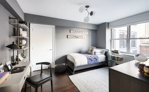 a bedroom with bed and a window