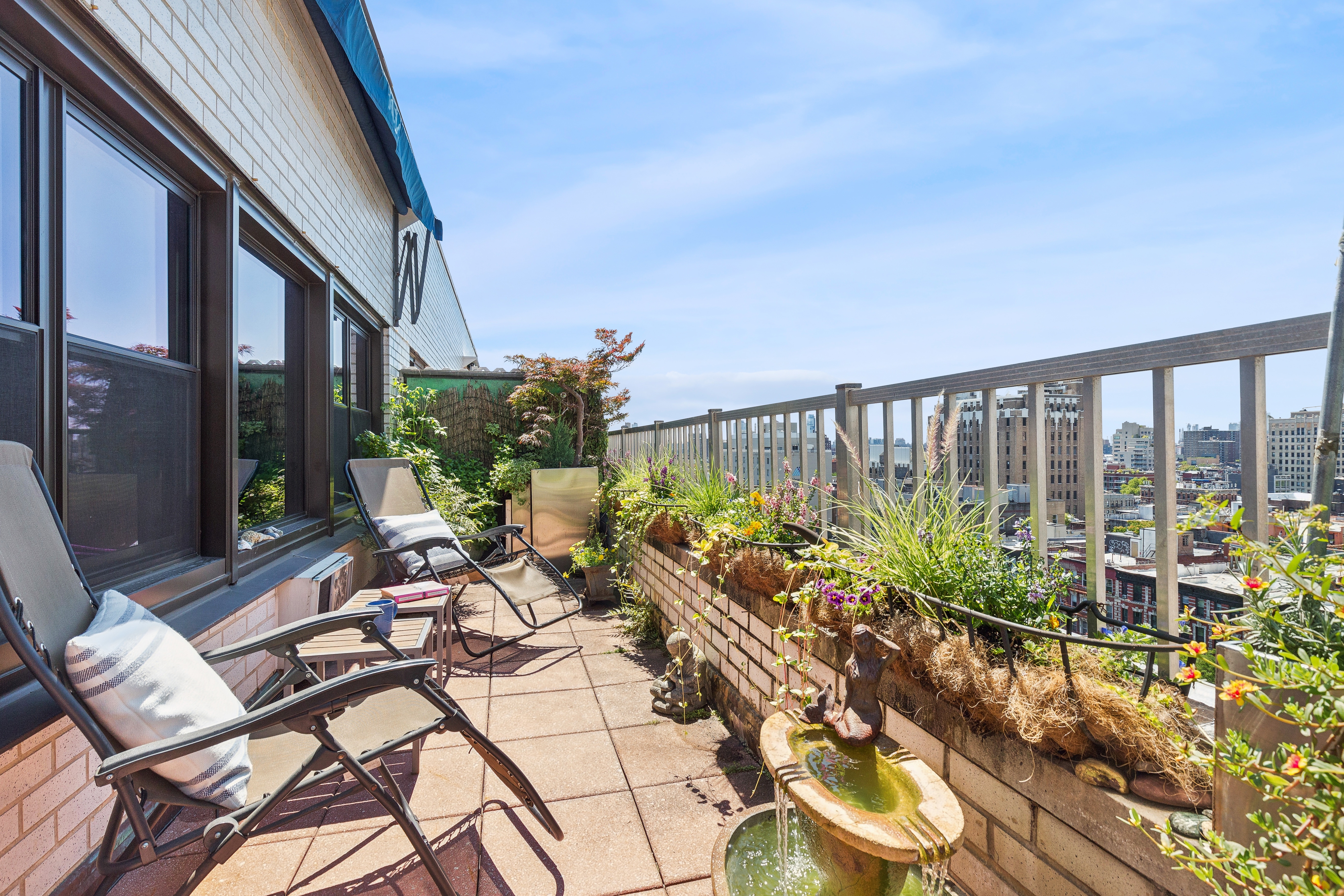 210 East 15th Street, Unit PHD Manhattan, NY 10003 - Photo 10 of 12 a view of a chairs and table in a balcony