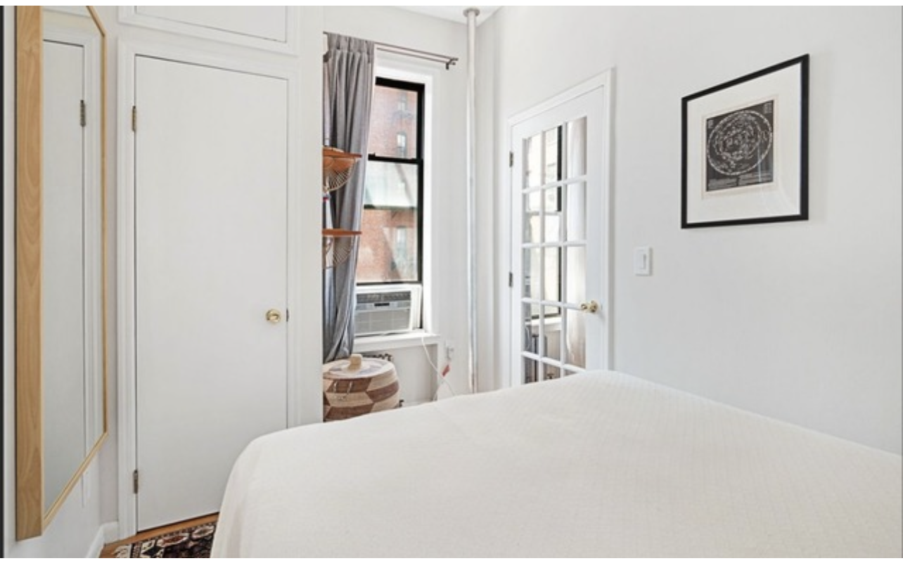 2 Bethune Street, Unit 1B Manhattan, NY 10014 - Photo 4 of 4 a bedroom with a bed and a painting on the wall