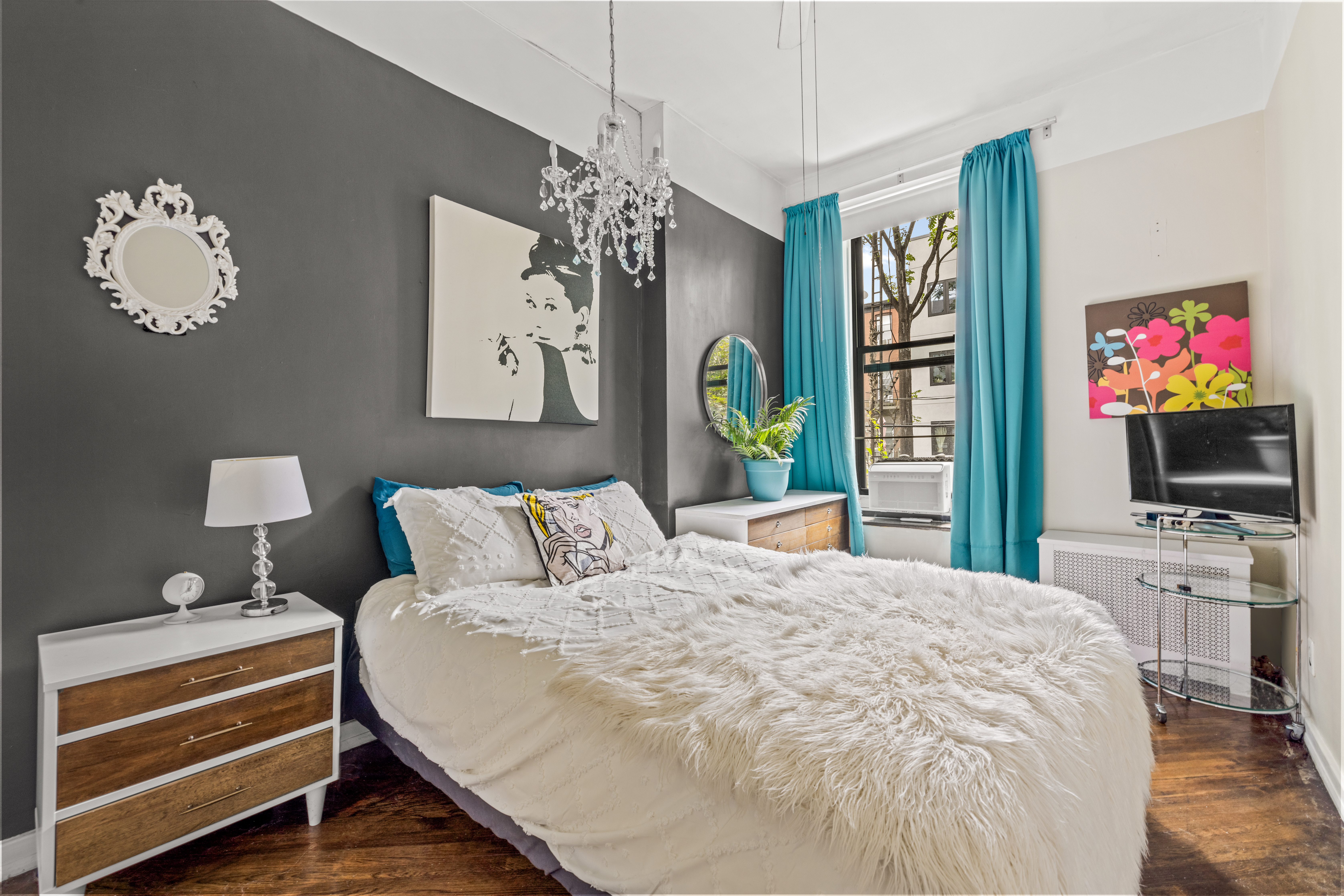 376 Bergen Street, Unit 1R Brooklyn, NY 11217 - Photo 7 of 10 a bedroom with a bed and a flat screen tv