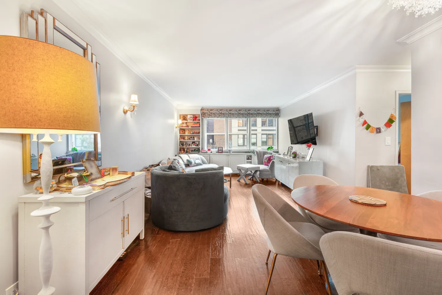 a dining room with furniture and a flat screen tv