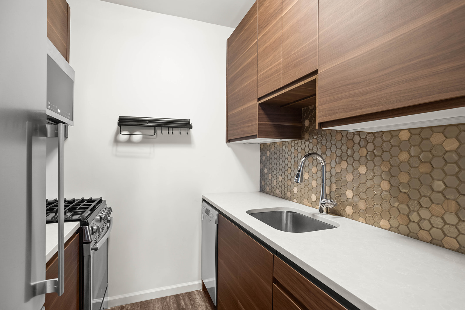 233 East 86th Street, Unit 16A Manhattan, NY 10028 - Photo 2 of 7 a kitchen with a sink a refrigerator and a stove