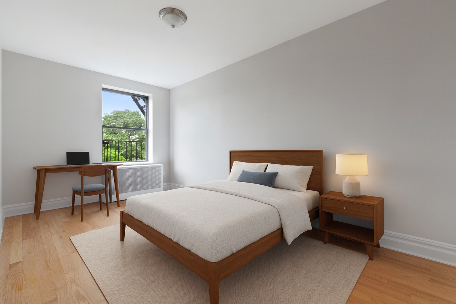 690 Riverside Drive, Unit 5D Manhattan, NY 10031 - Photo 4 of 9 a bedroom with a bed a table and a two windows