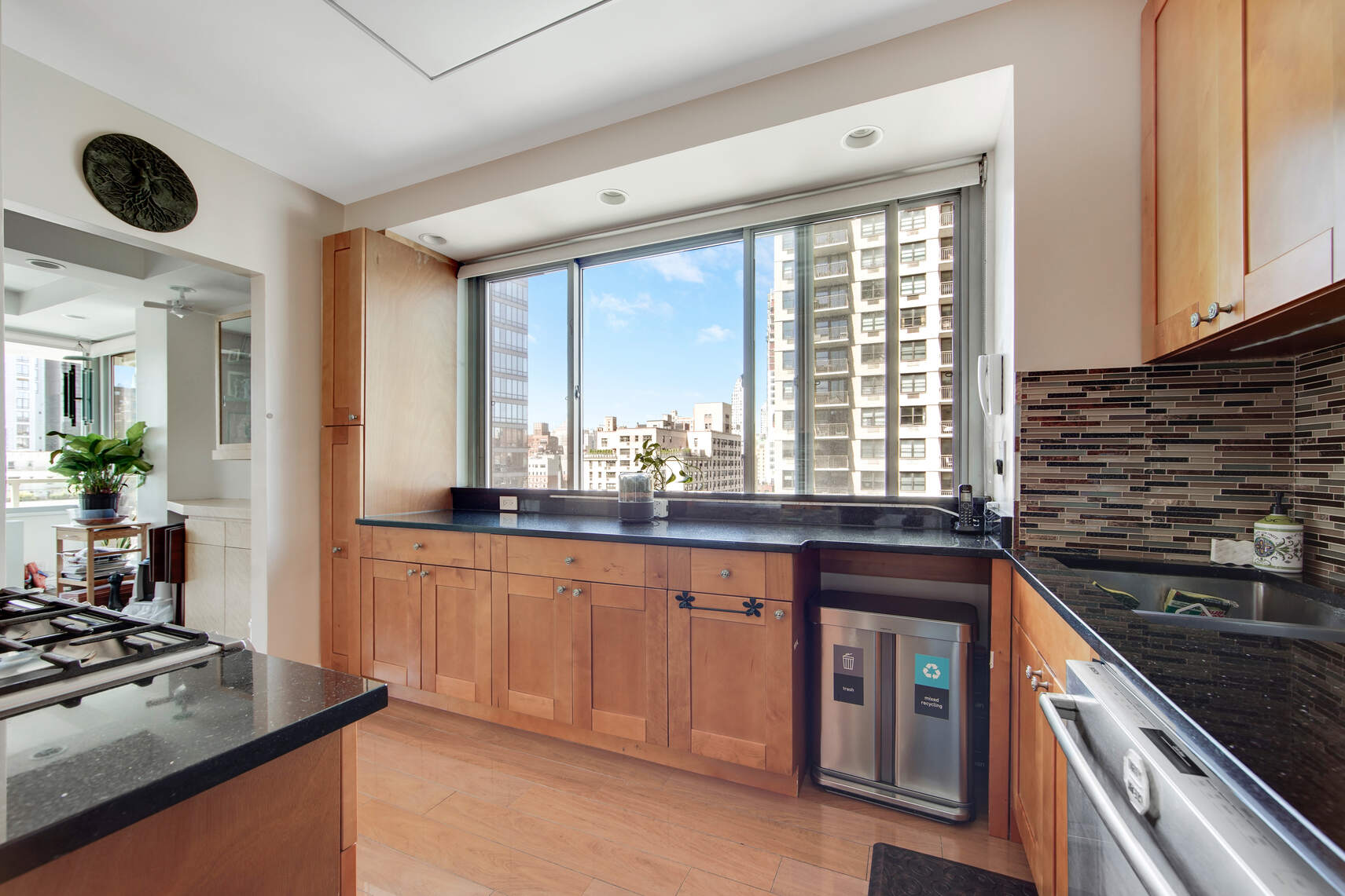 300 East 74th Street, Unit 14F Manhattan, NY 10021 - Photo 6 of 13 a kitchen with granite countertop a sink and a stove