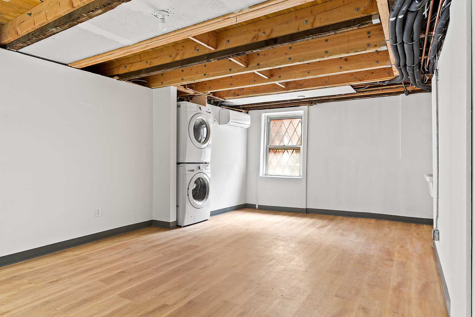 69 Hudson Avenue, Unit HSE Brooklyn, NY 11201 - Photo 19 of 20 a view of an empty room with wooden floor and a window