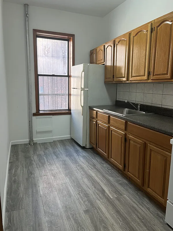 571 Nostrand Avenue, Unit 3R Brooklyn, NY 11216 - Photo 1 of 7 a kitchen with stainless steel appliances granite countertop a sink a stove cabinets and wooden floor