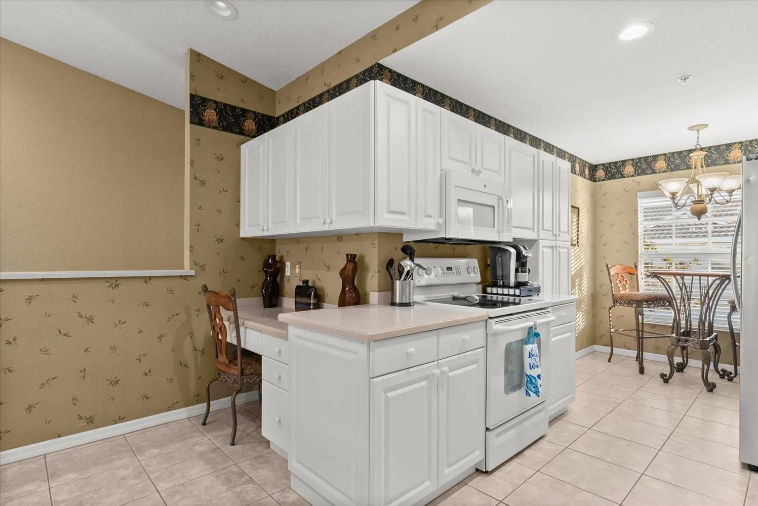 a kitchen with a sink a refrigerator and cabinets