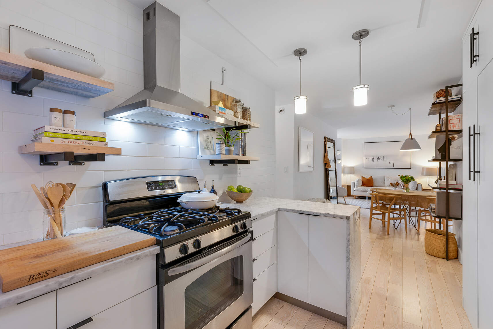 201 East 21st Street, Unit 4M Manhattan, NY 10010 - Photo 5 of 11 a kitchen with stainless steel appliances granite countertop a stove and a wooden floors