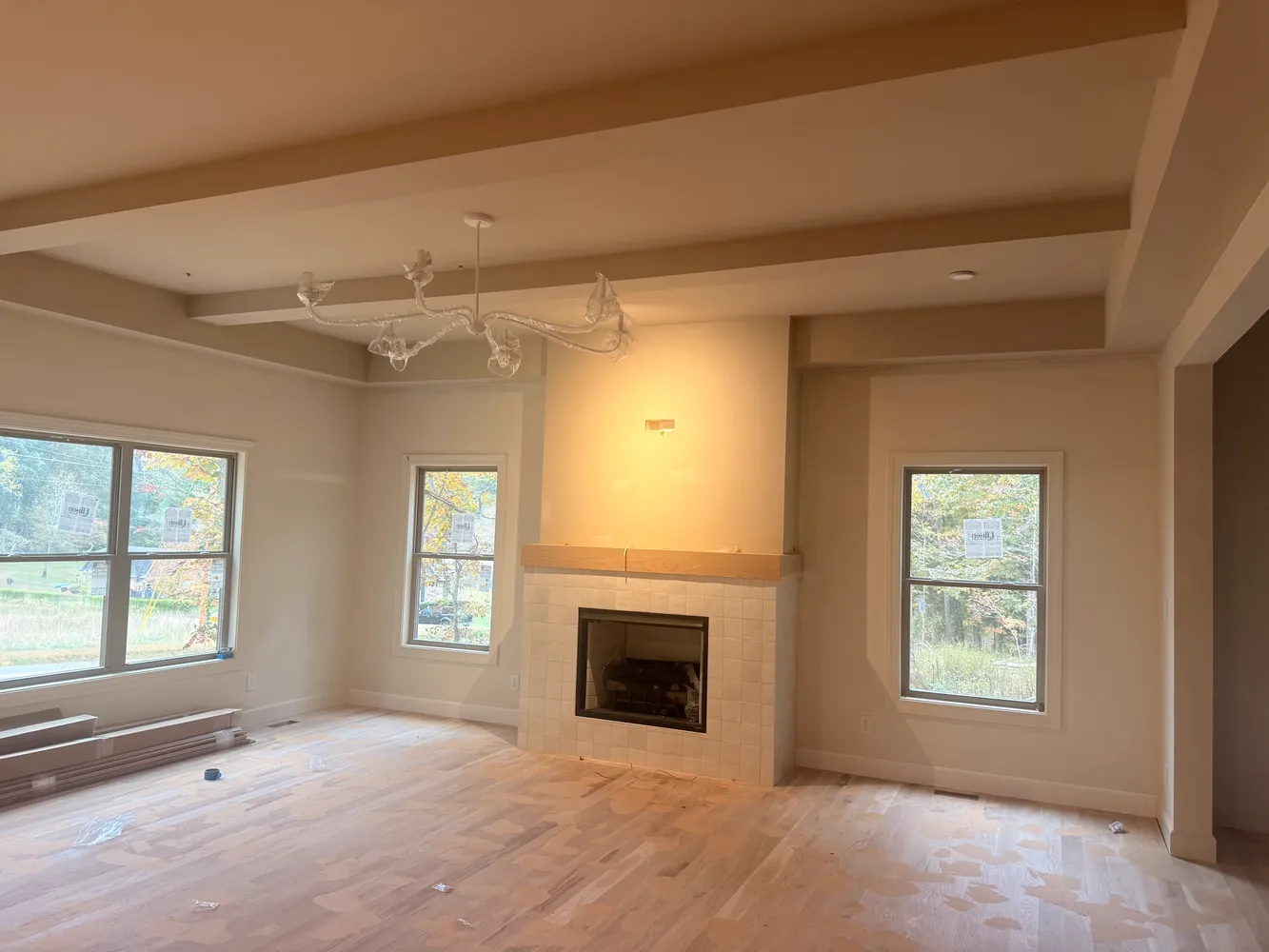 a view of an empty room with a window and fireplace