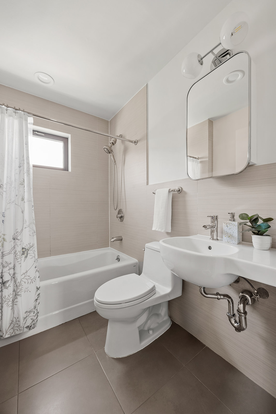 20 Tiffany Place, Unit 5S Brooklyn, NY 11231 - Photo 9 of 12 a bathroom with a sink a toilet and a bathtub