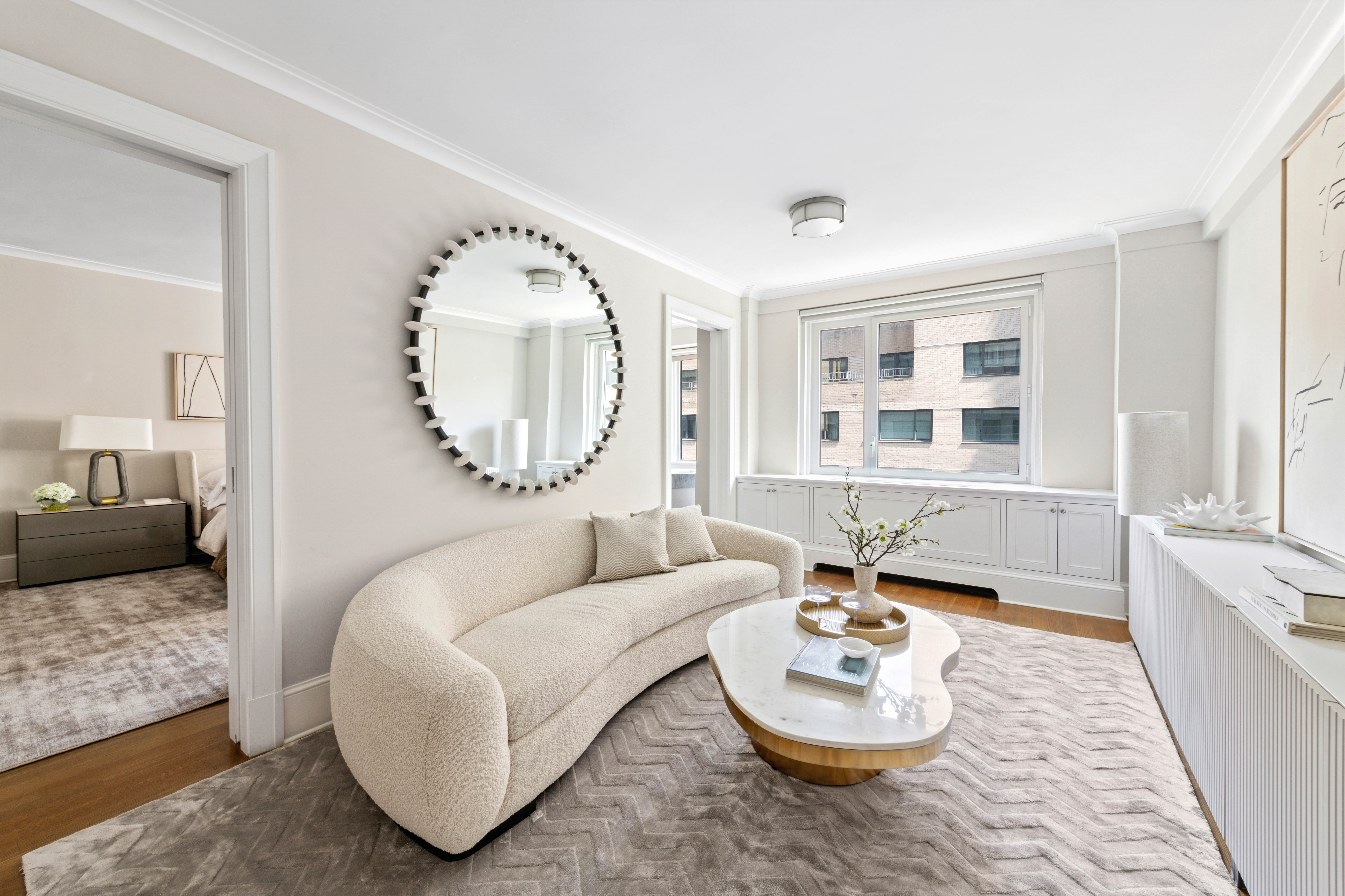 530 Park Avenue, Unit 12F Manhattan, NY 10065 - Photo 10 of 26 a living room with furniture and a large window