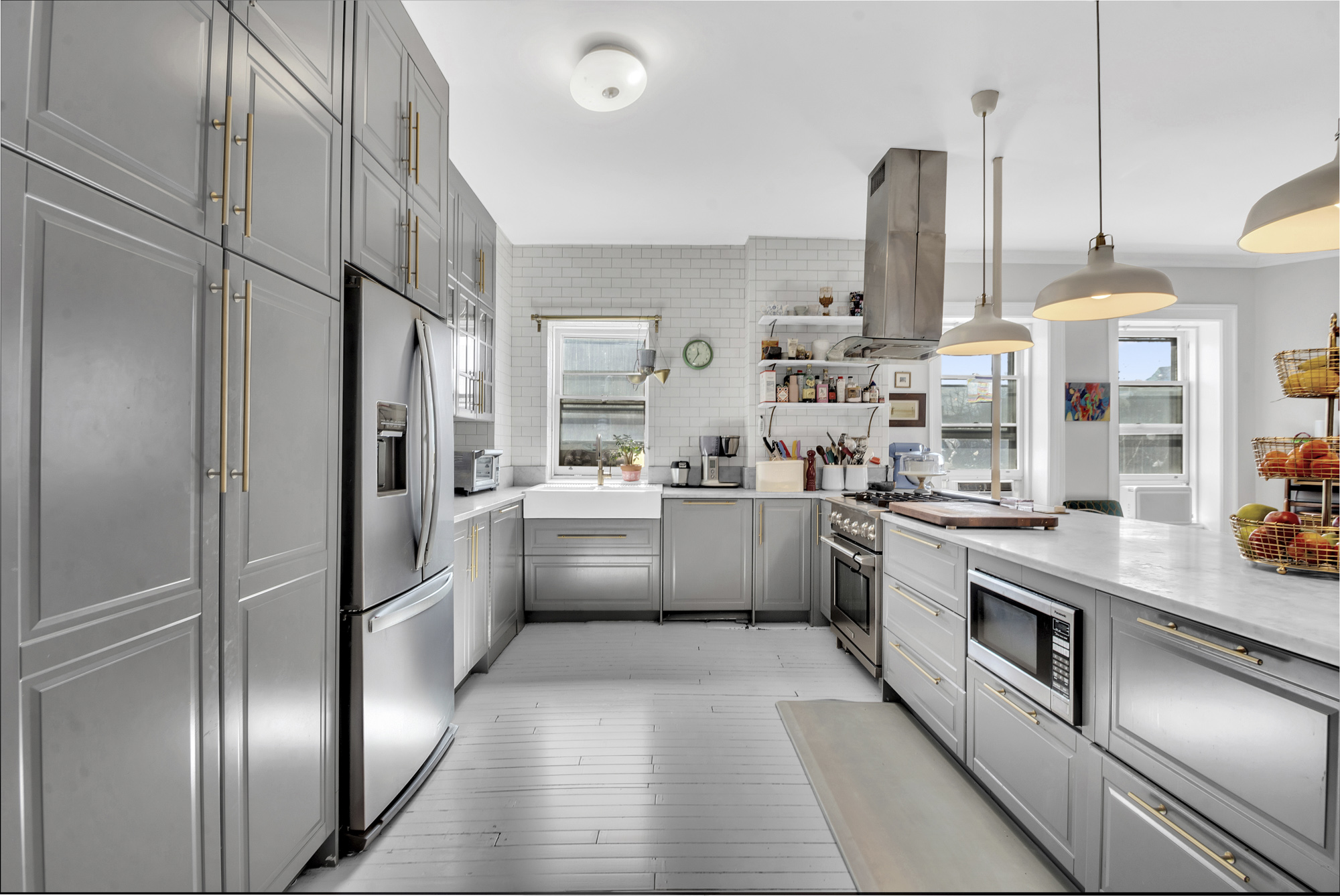 275 Clinton Avenue, Unit 4-1 Brooklyn, NY 11205 - Photo 8 of 20 a kitchen with white cabinets and stainless steel appliances