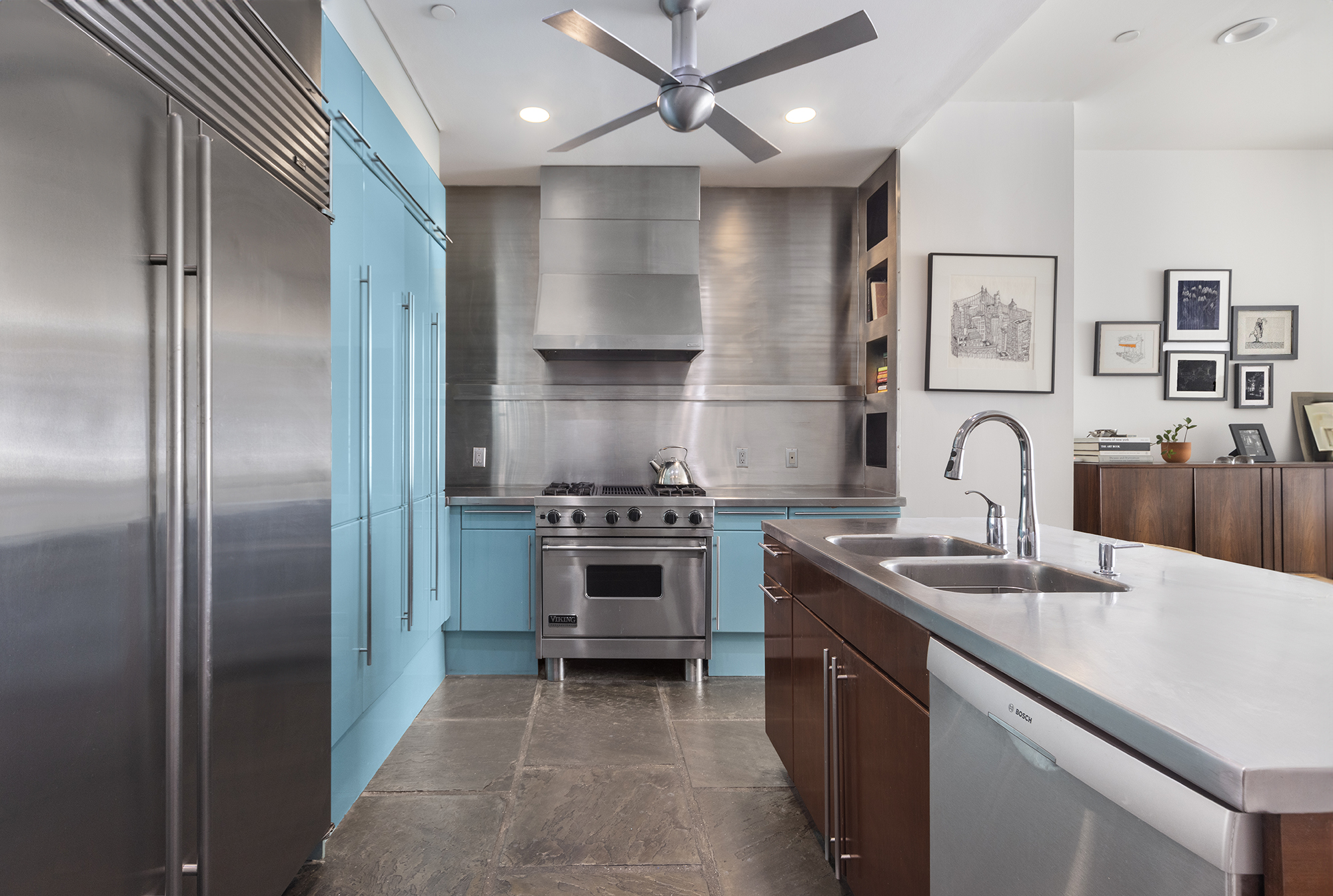 25 Leonard Street, Unit 2 New York, NY 10013 - Photo 4 of 12 a kitchen with stainless steel appliances granite countertop a sink stove and refrigerator