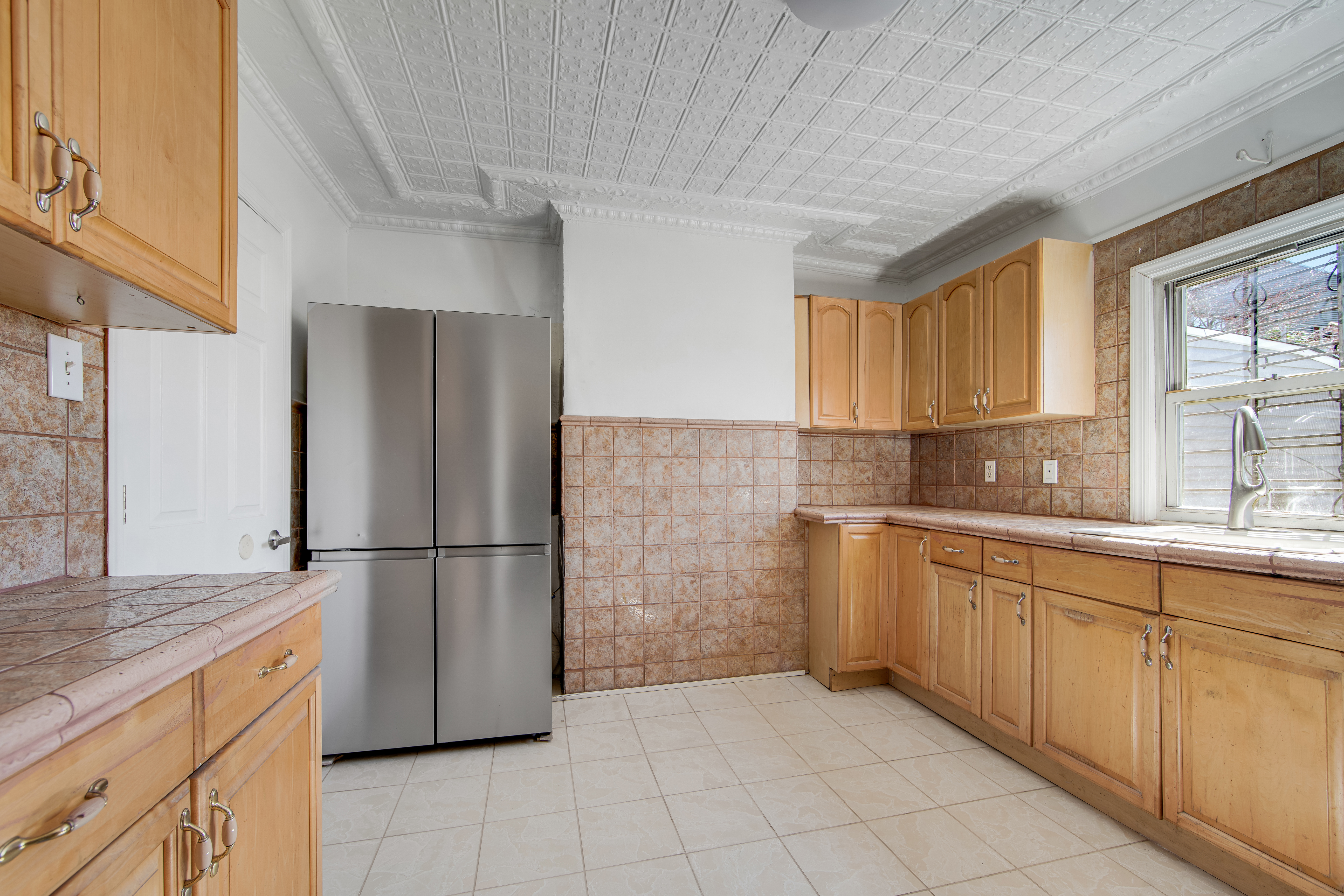296 17th Street Brooklyn, NY 11215 - Photo 4 of 8 a kitchen with a refrigerator sink and cabinets