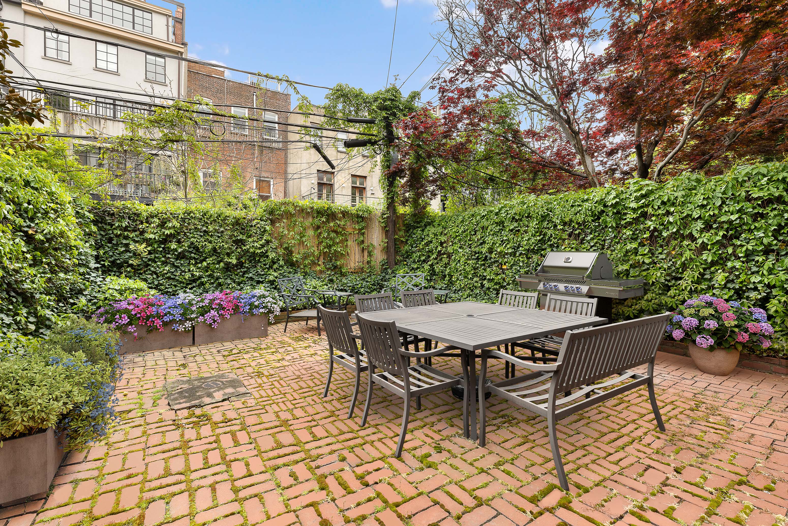 144 Baltic Street Brooklyn, NY 11201 - Photo 11 of 14 a view of a patio with a table and chairs and potted plants
