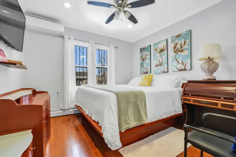 a bedroom with furniture and a flat screen tv