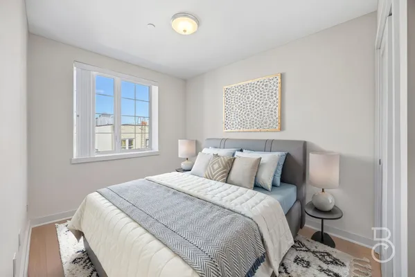 a bedroom with a bed and a window