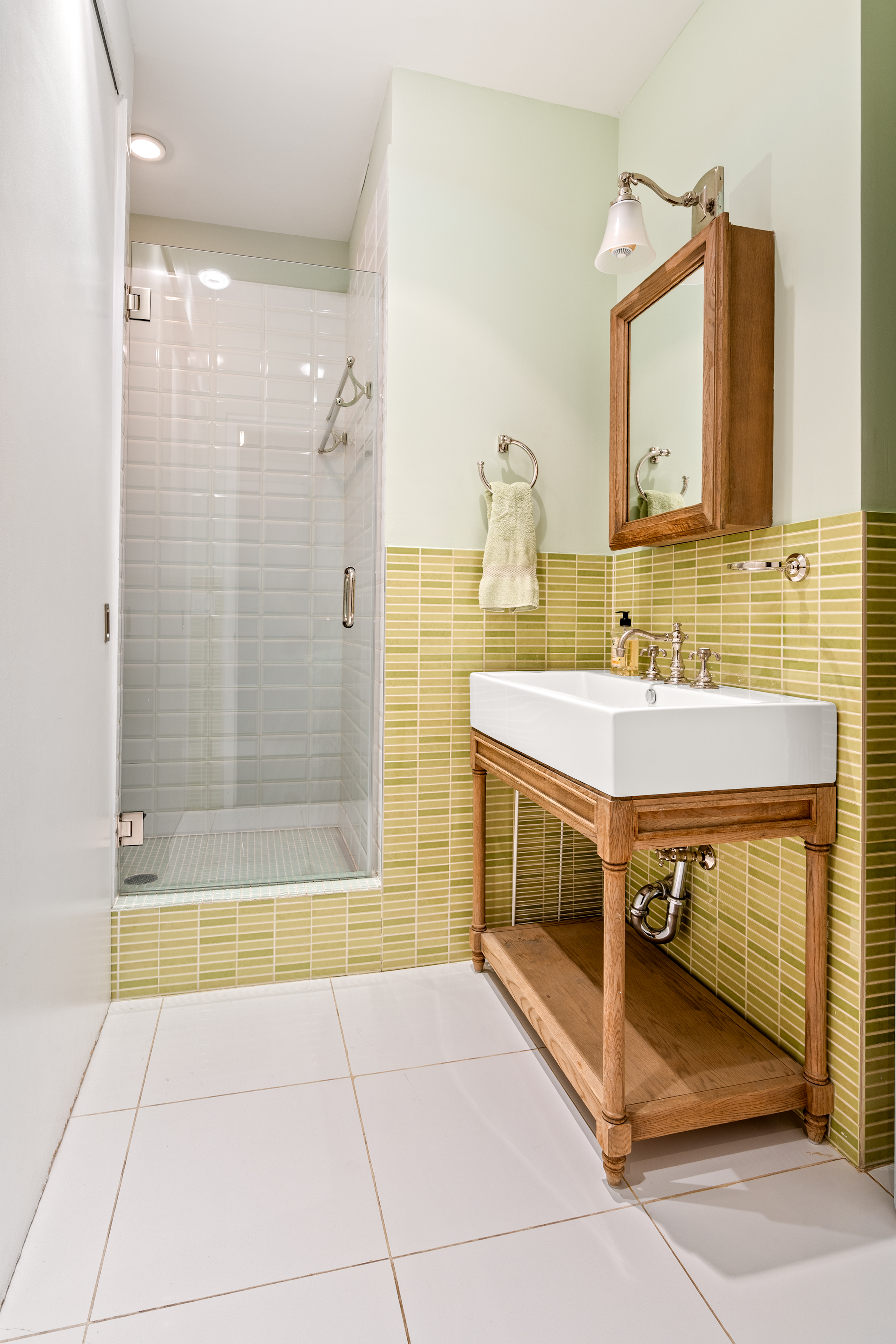 160 Chambers Street, Unit 3 Manhattan, NY 10007 - Photo 8 of 9 a bathroom with a sink a mirror and a bathtub