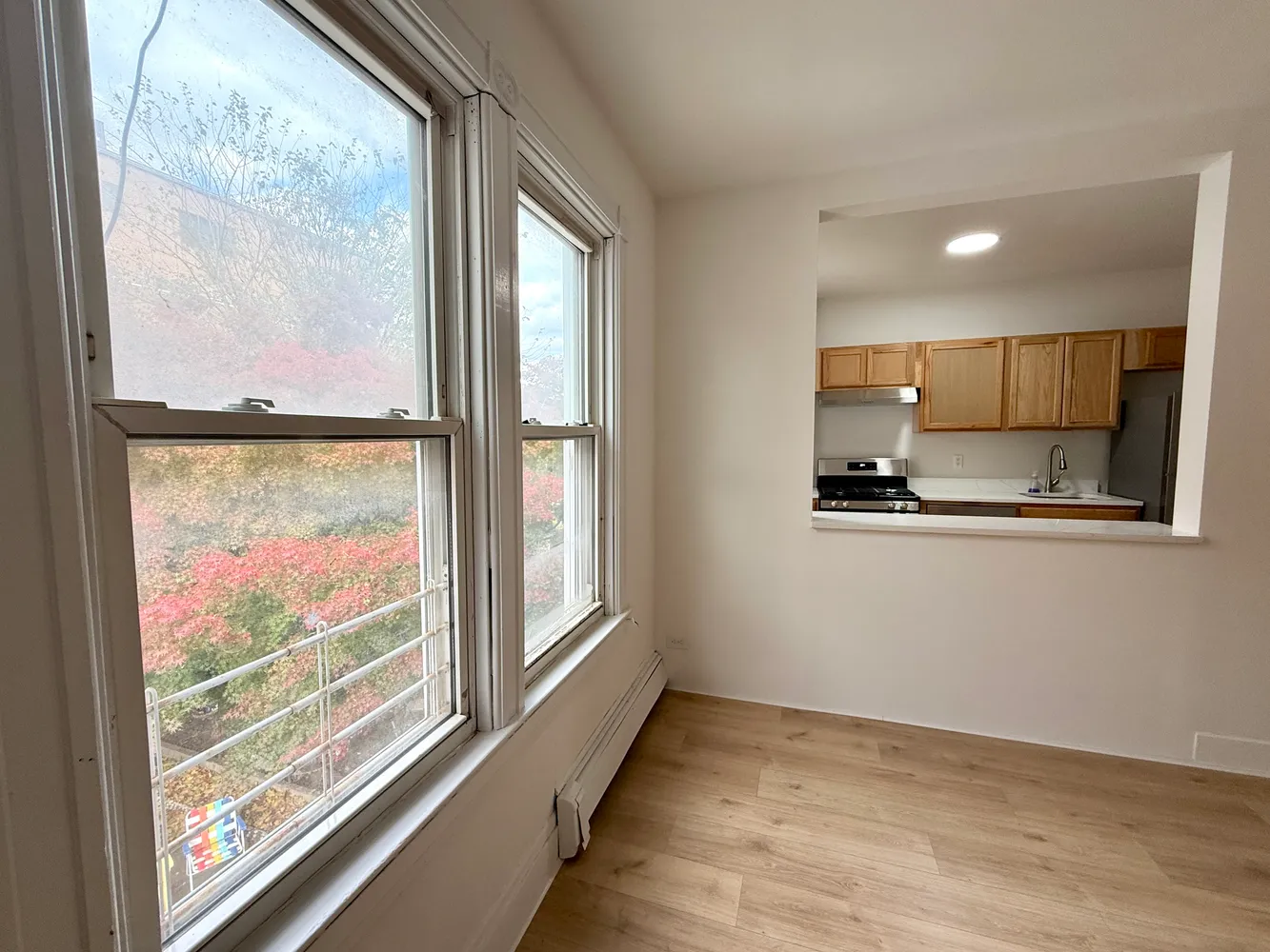 a view of kitchen with microwave and refrigerator