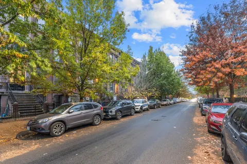 a view of car parked on the side of a street