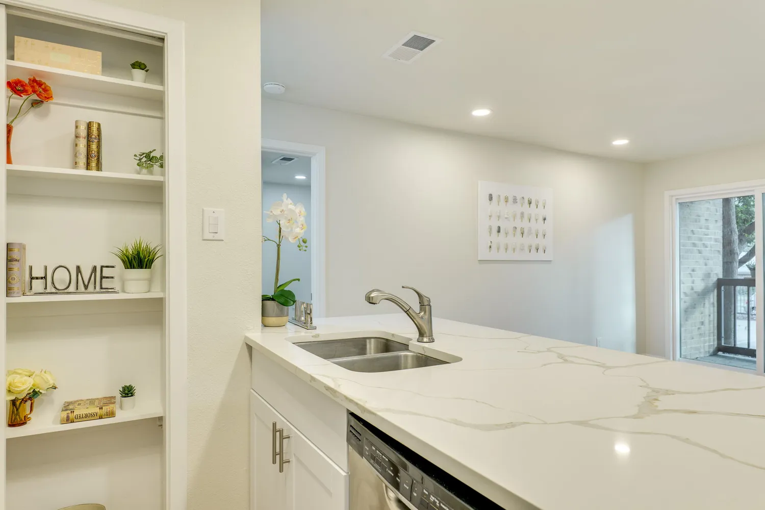 a kitchen with stainless steel appliances a stove a sink and a microwave