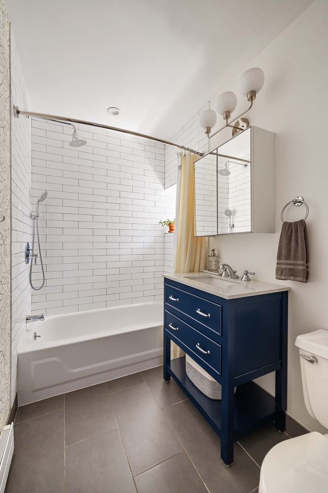 a bathroom with a sink a toilet and bathtub