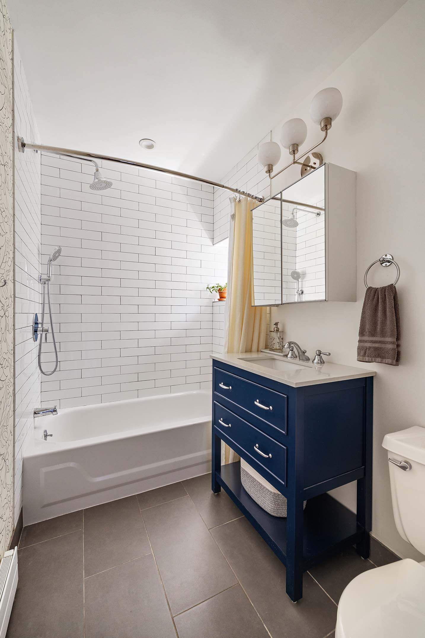 702 East 5th Street, Unit 5E Manhattan, NY 10009 - Photo 10 of 14 a bathroom with a sink a toilet and bathtub