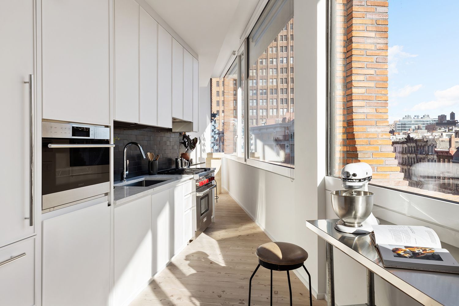 a kitchen with a stove a table and chairs in it