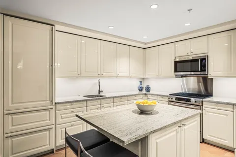 a kitchen with a sink appliances and cabinets