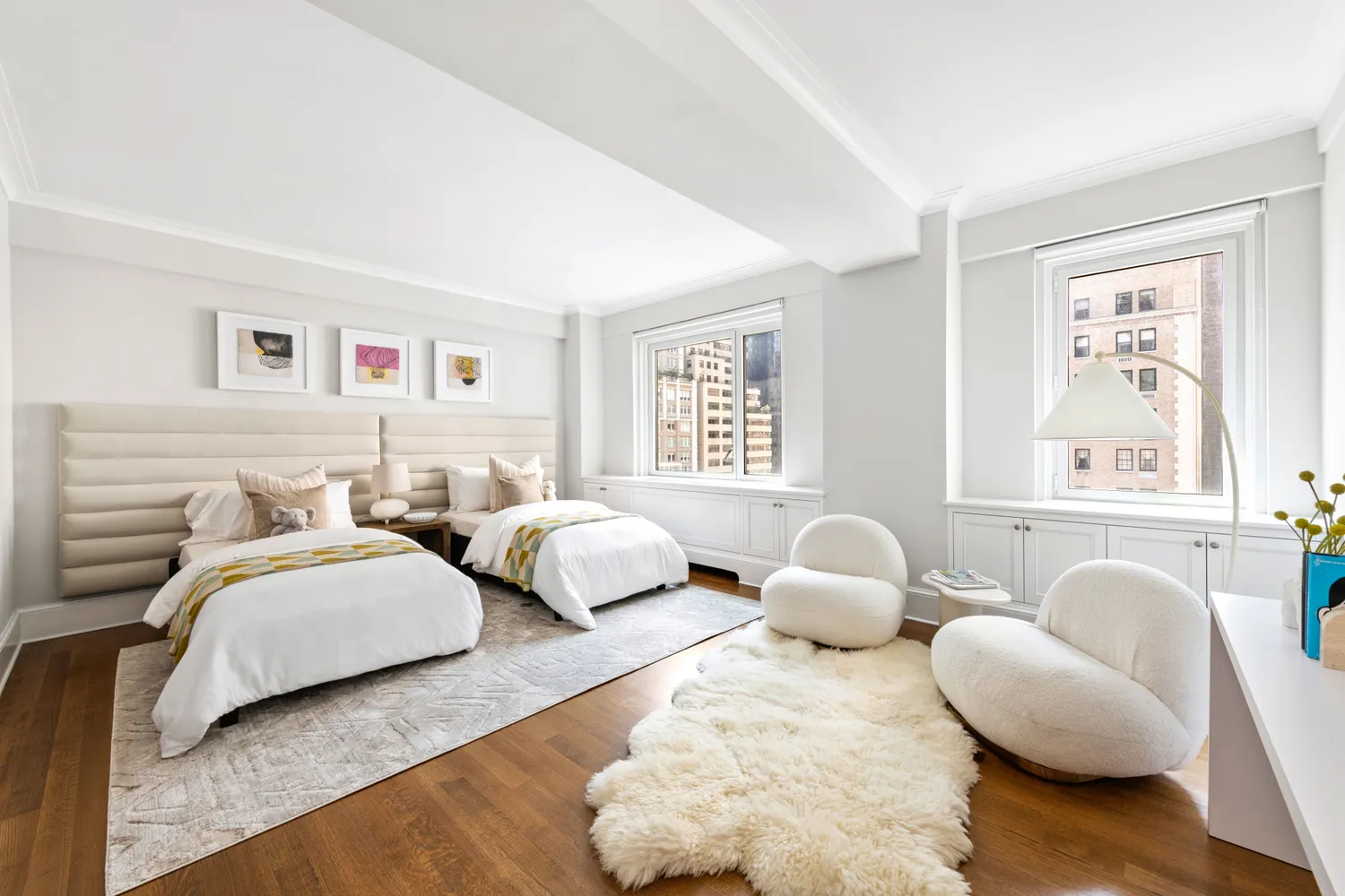 a bedroom with two beds and a large window