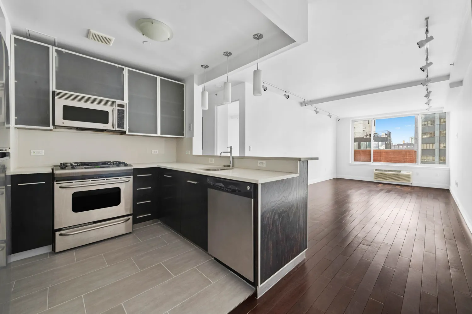 a kitchen with stainless steel appliances and wooden cabinets