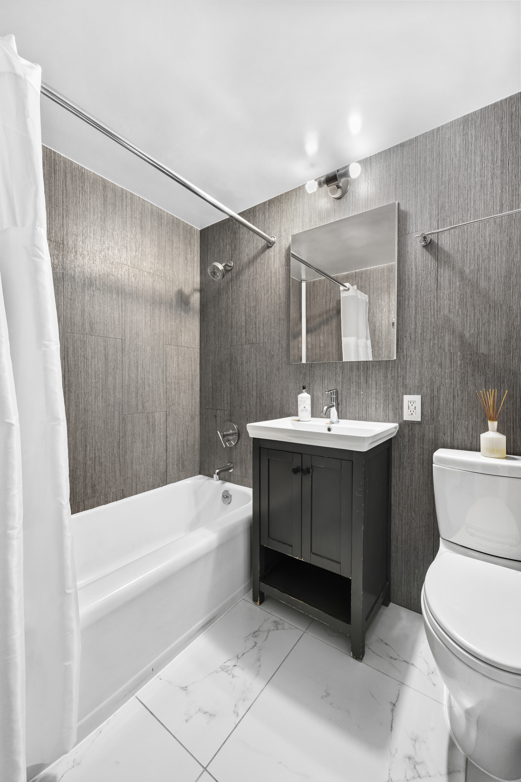 80 Park Avenue, Unit 11D Manhattan, NY 10016 - Photo 6 of 7 a bathroom with a sink a toilet and shower