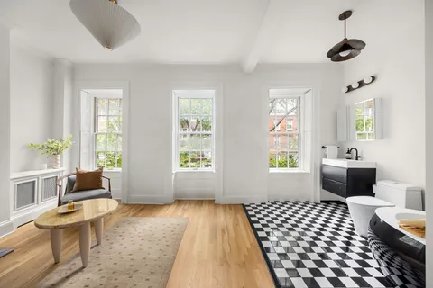 a bedroom with furniture and a fireplace