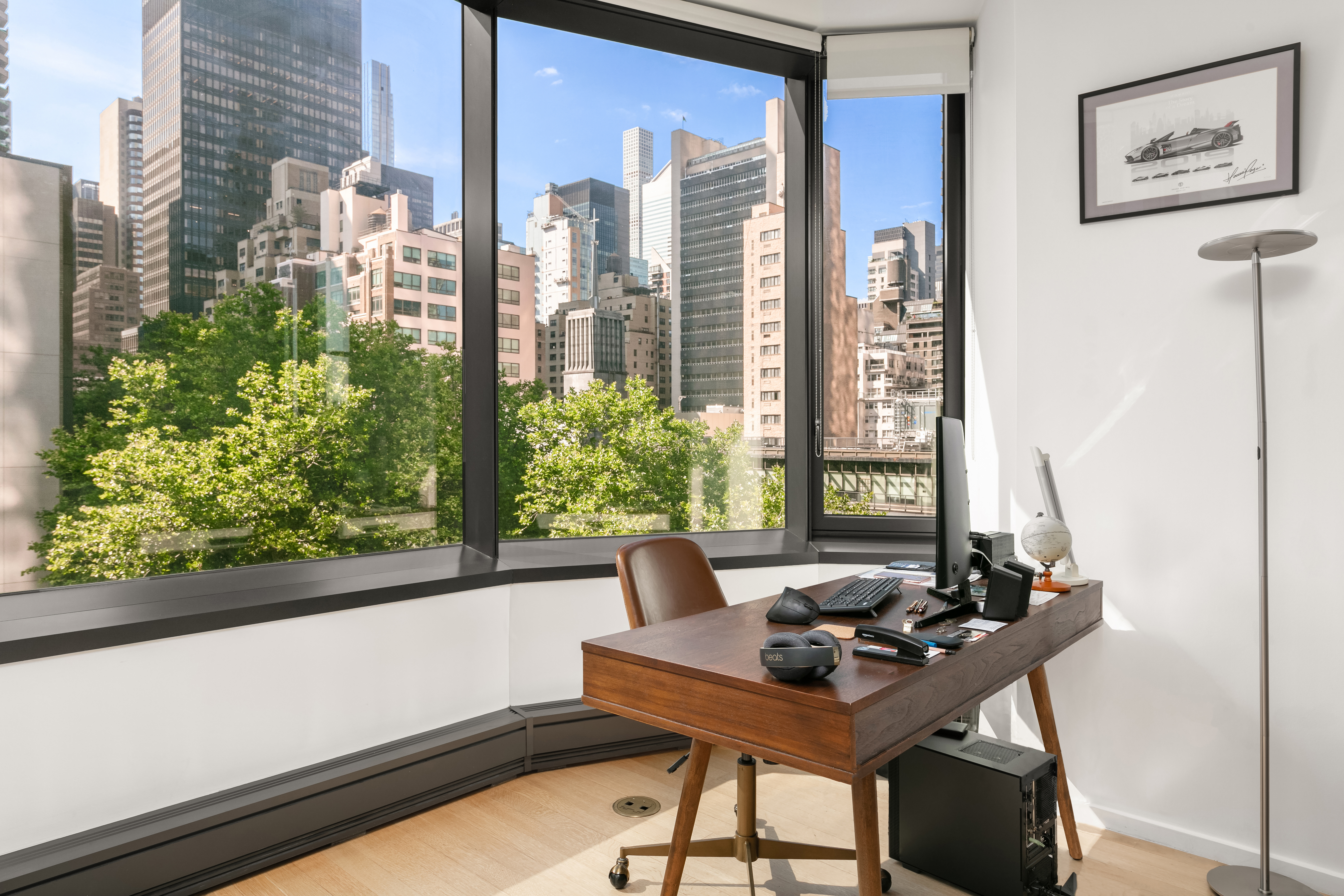 50 United Nations Plaza, Unit 6C Manhattan, NY 10017 - Photo 3 of 15 a living room with furniture and a potted plant