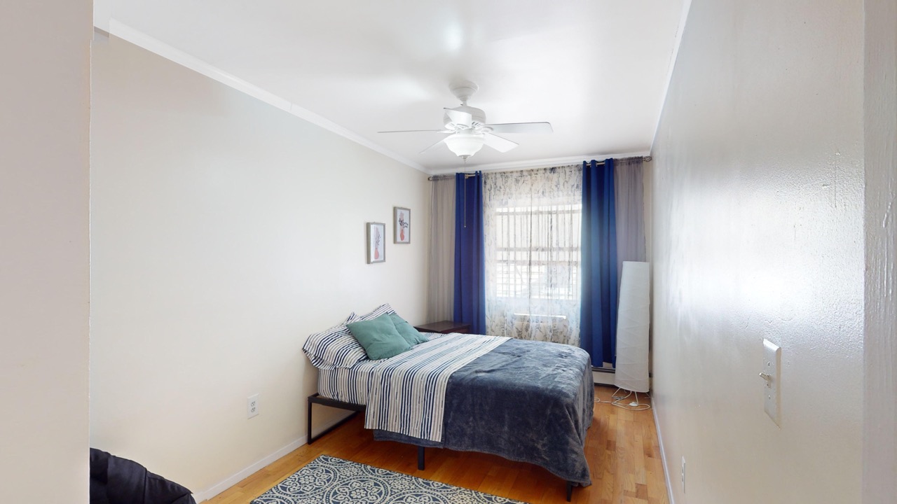 495 Central Avenue, Unit 2 Brooklyn, NY 11221 - Photo 11 of 19 a bedroom with a bed and a window