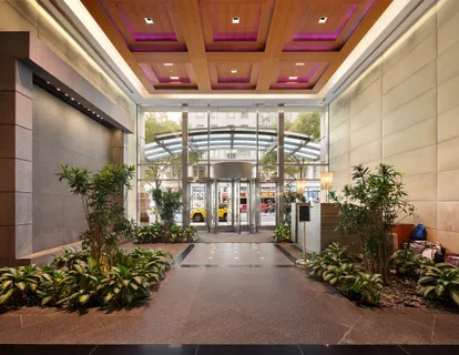 a lobby with furniture and potted plants